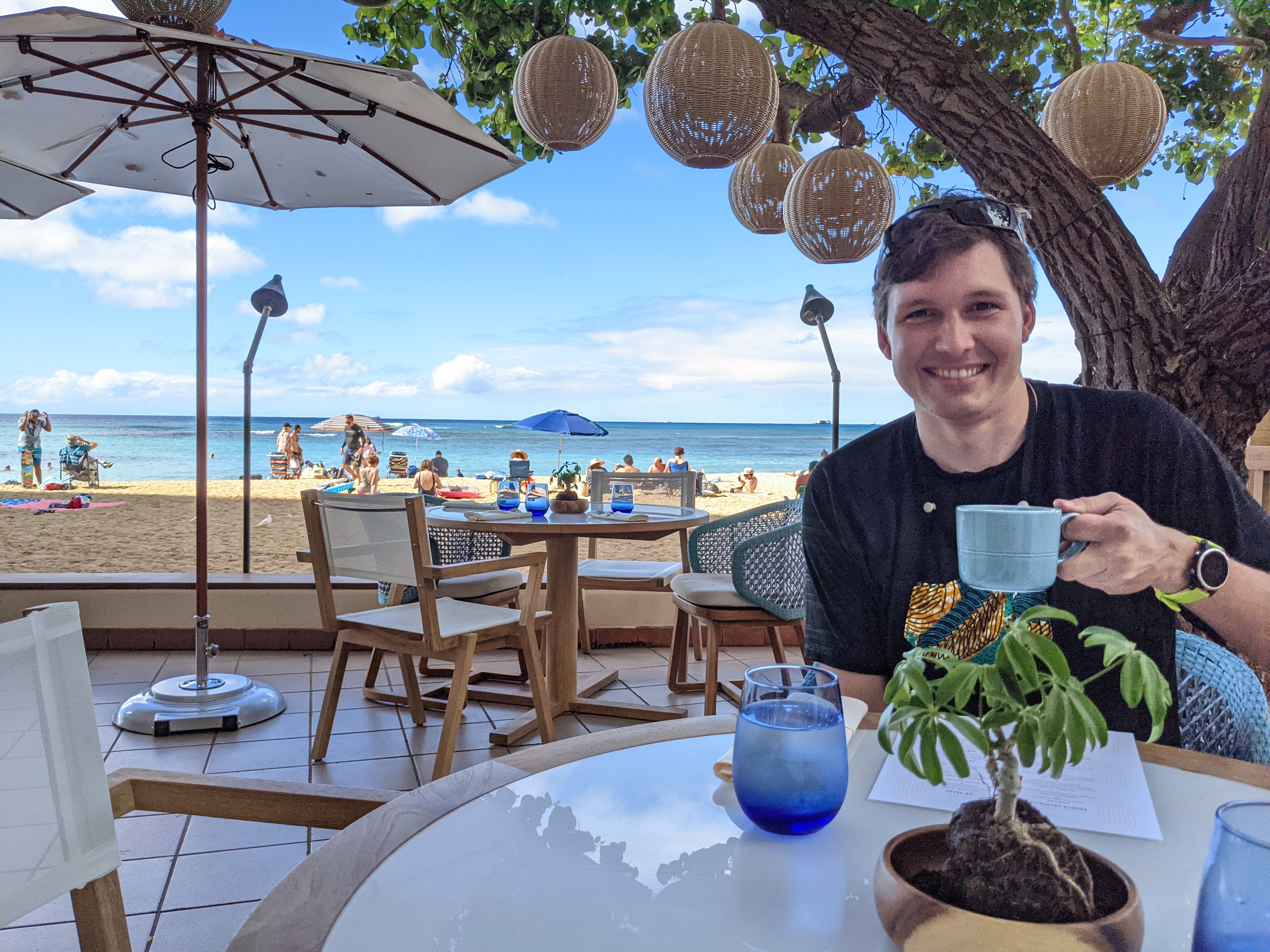 Malcolm drinking coffee at a restaurant