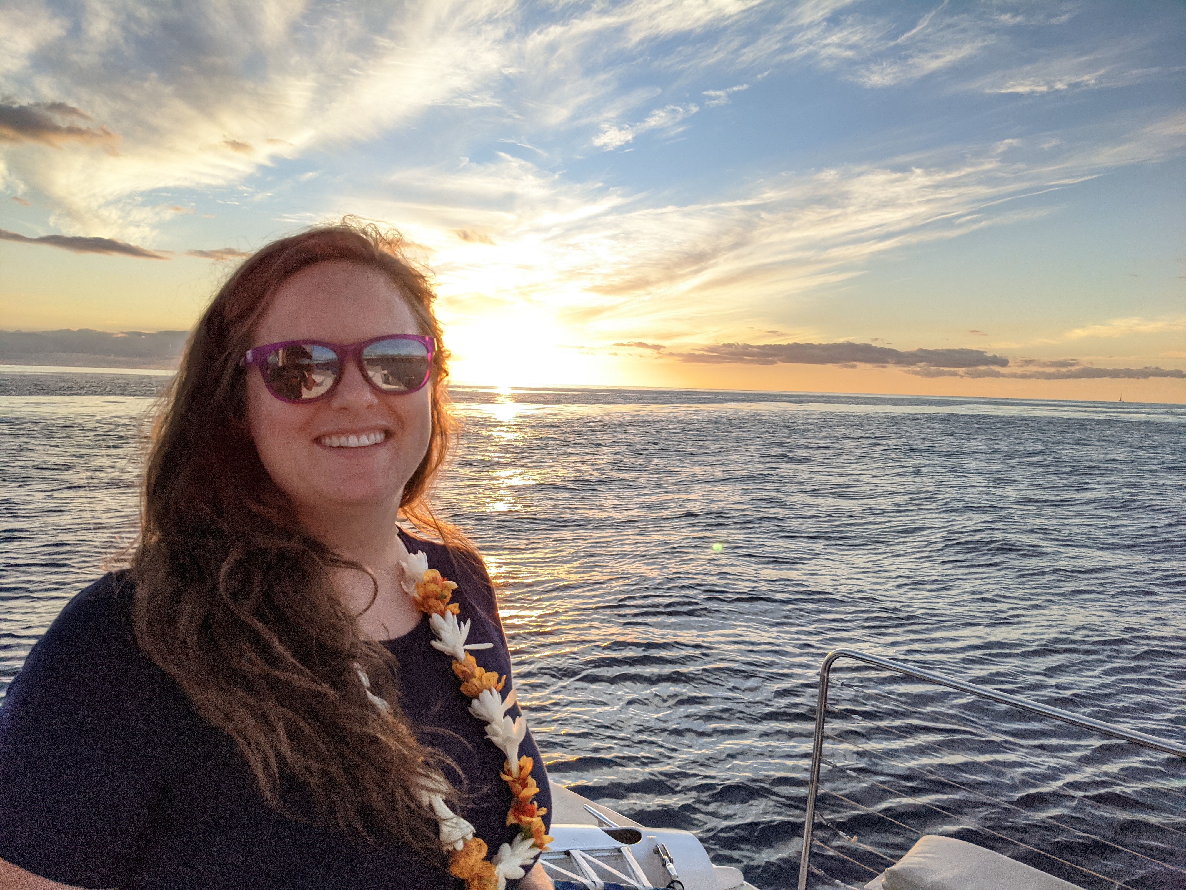 Kimberly on a boat with sunset in the background